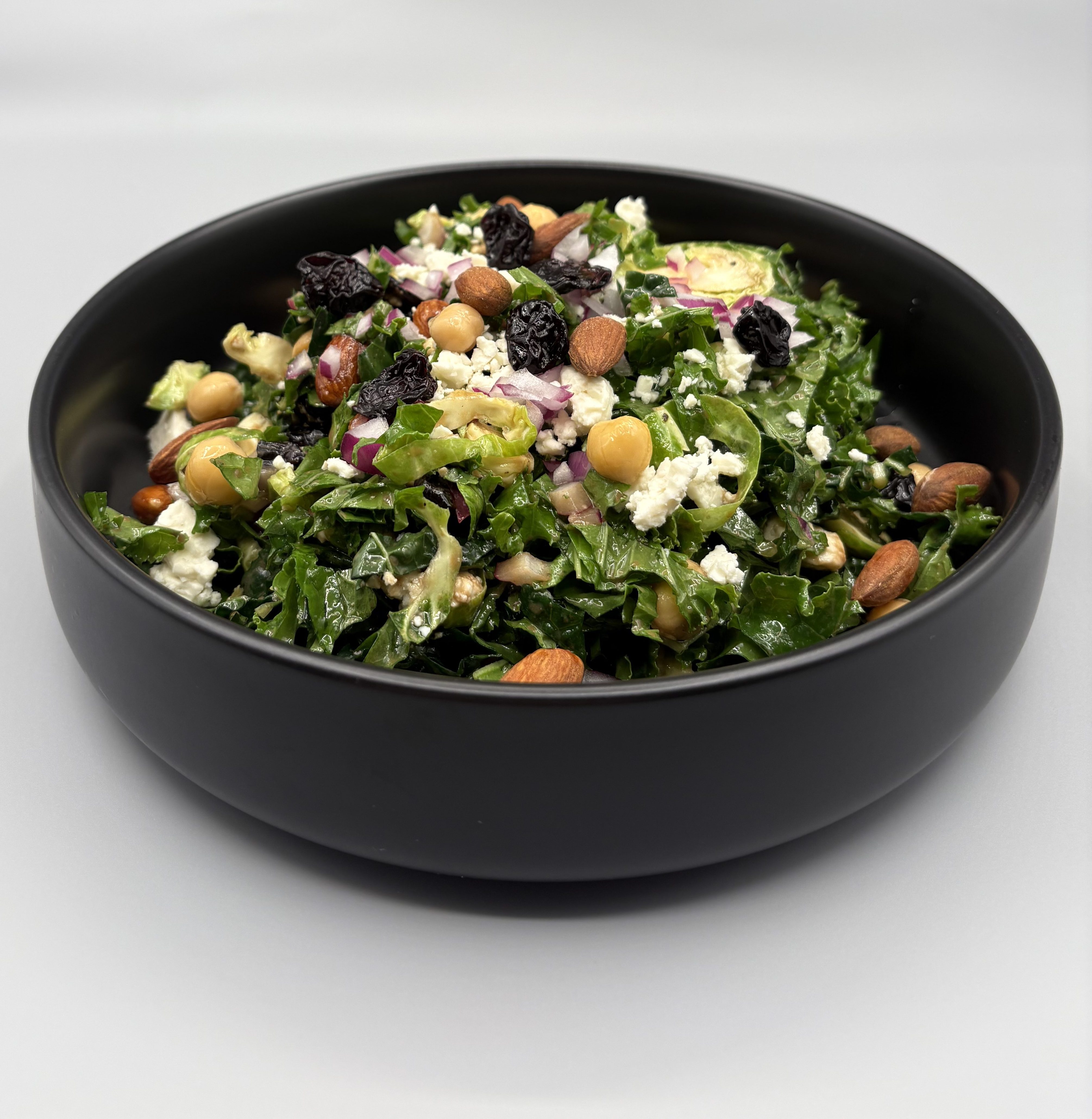 Kale & Shaved Brussels Sprouts Salad with Blue Cheese, Dried Cherries & Almonds